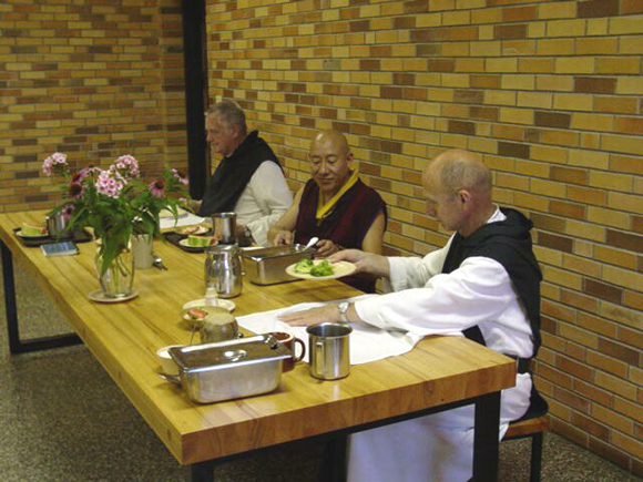 A Buddhist monk sharing a meal with Trappist monks